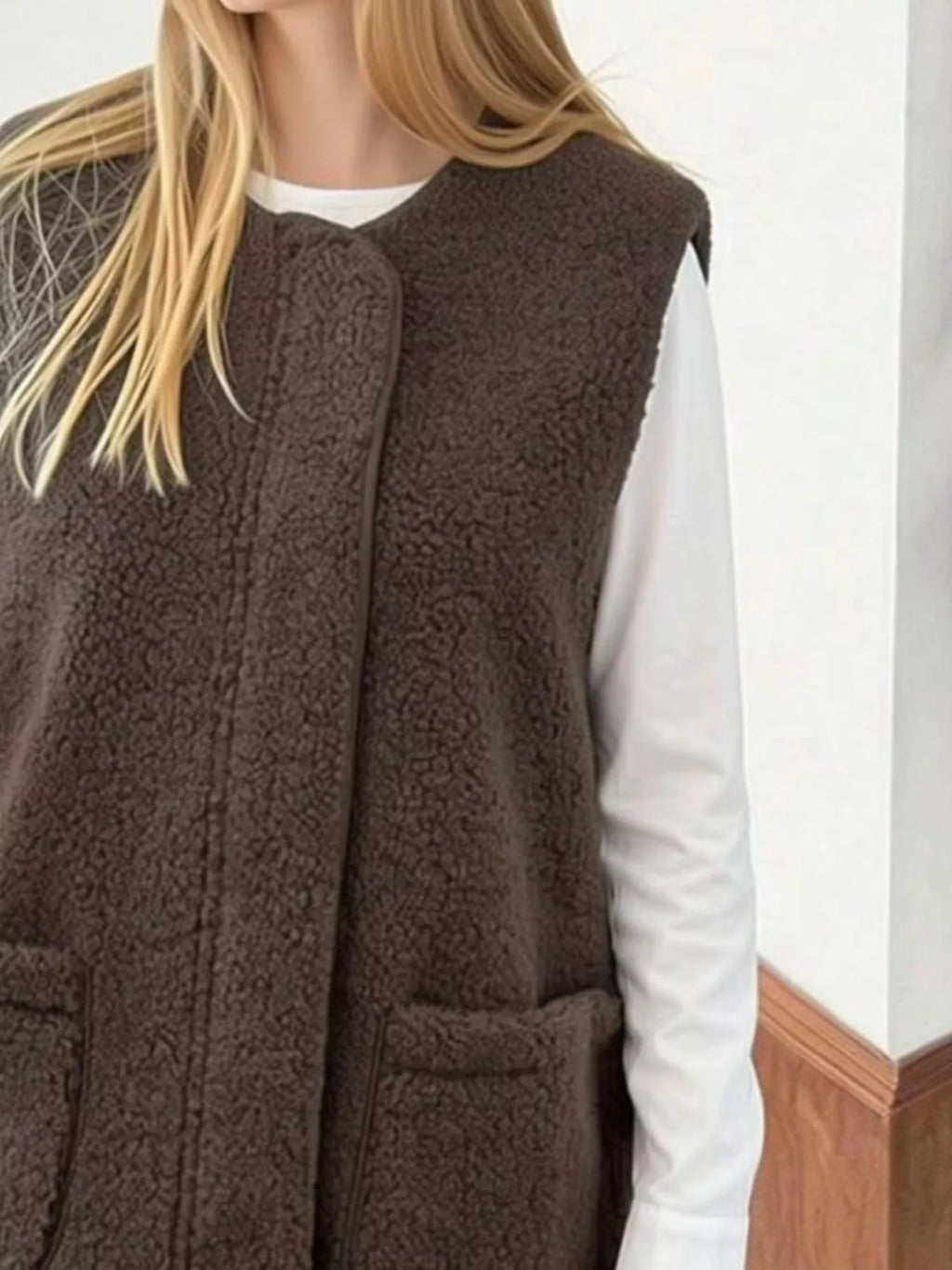 Close front view of the Coffee Brown sherpa vest worn over a white shirt.