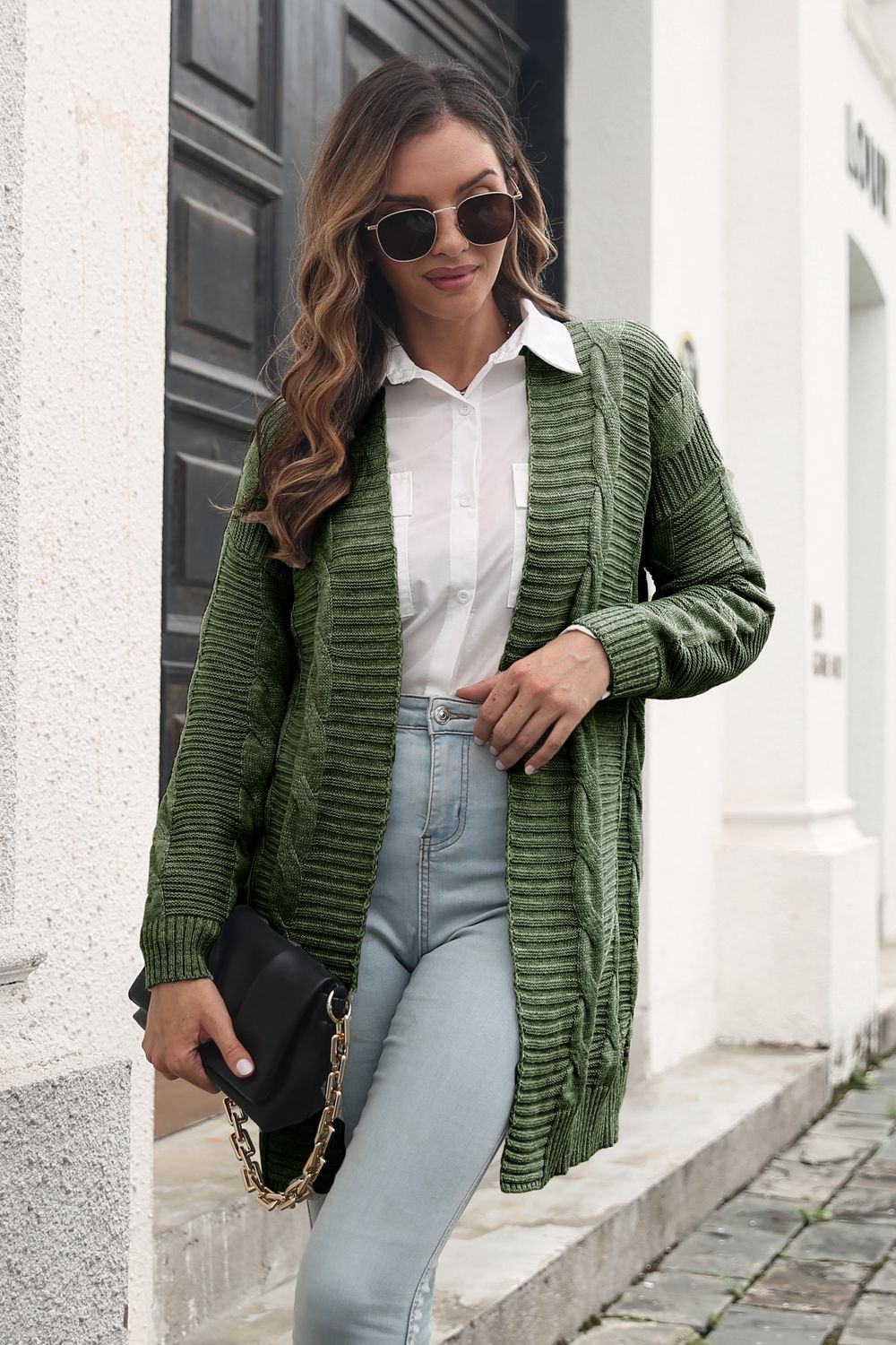 Army Green cable-knit cardigan styled with a black chain-strap bag.