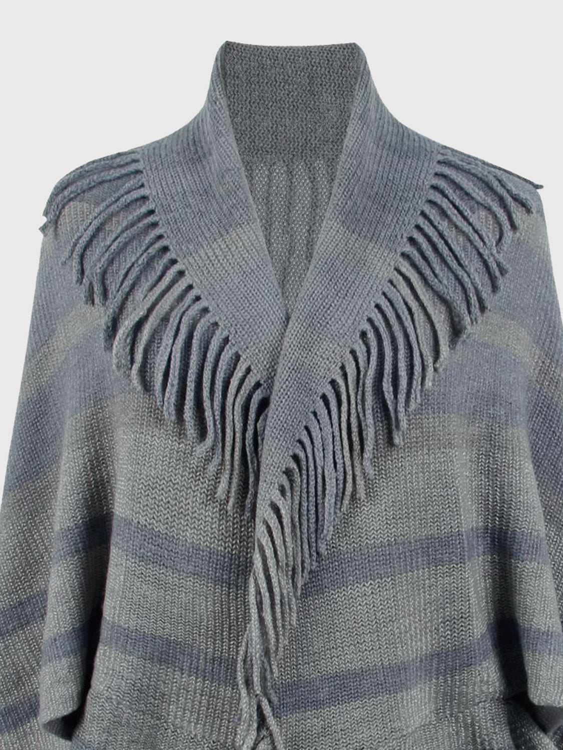 Close-up of the gray poncho's open neckline and fringed edges.