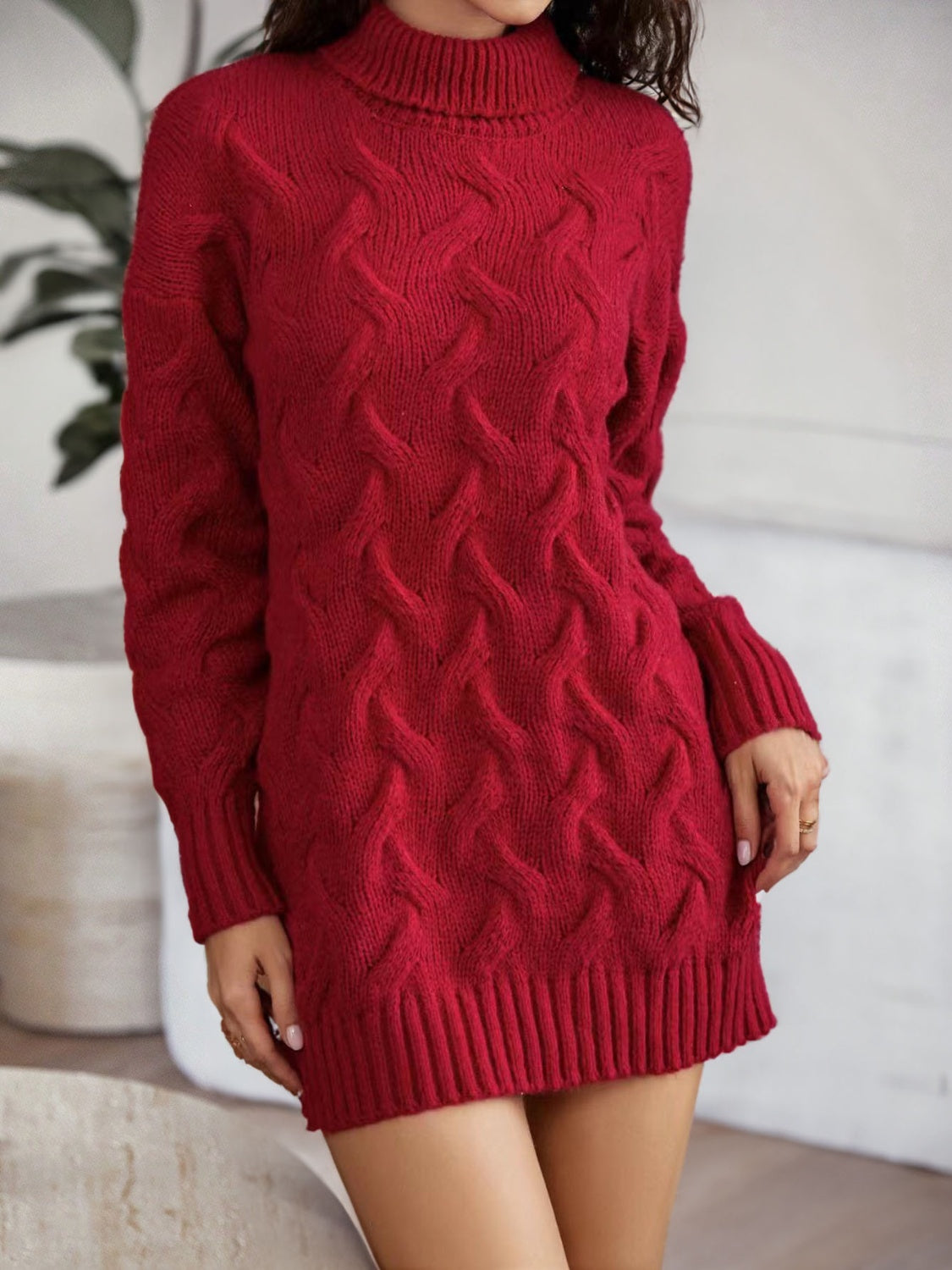 Front view of the burgundy cable-knit mini sweater dress with long sleeves.