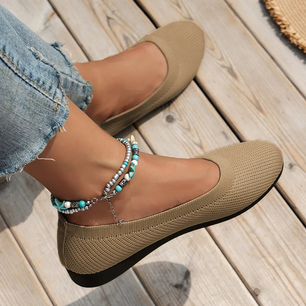 Khaki knit ballet flats worn with cropped jeans.