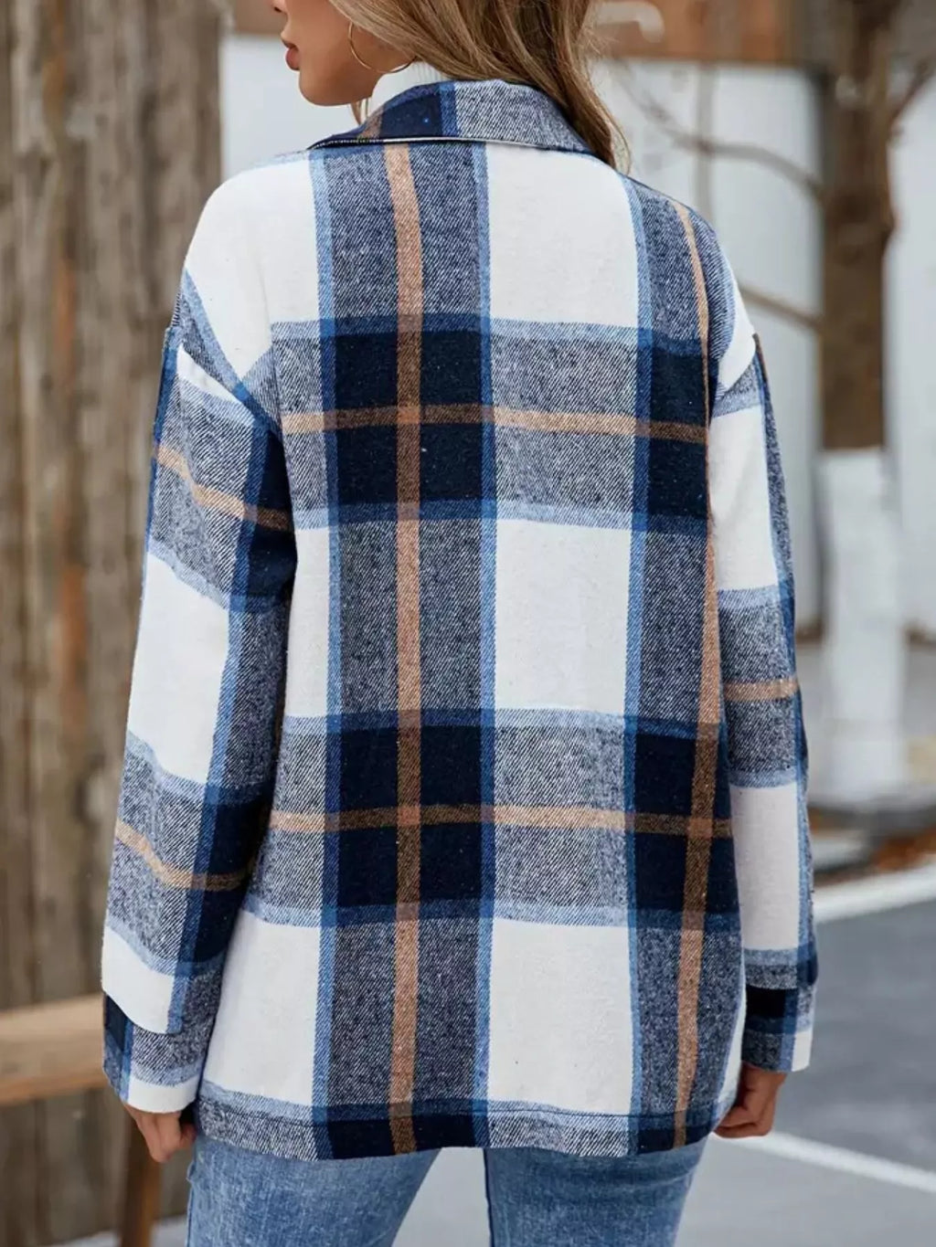 Back view of the blue and white plaid shacket worn with jeans.