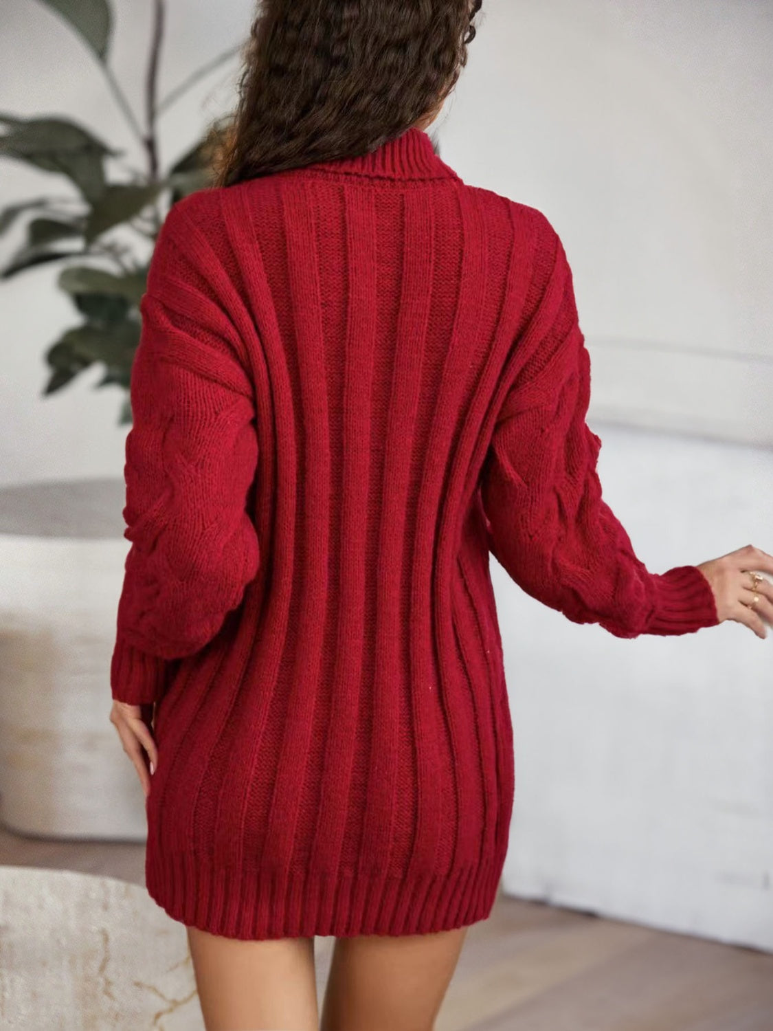 Back view of the burgundy sweater dress showing vertical ribs and a ribbed hem.