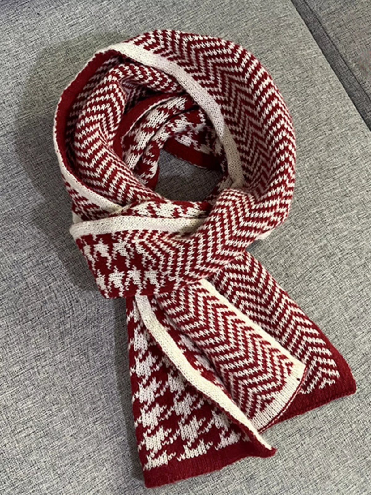 Burgundy scarf folded to show houndstooth and chevron patterns.
