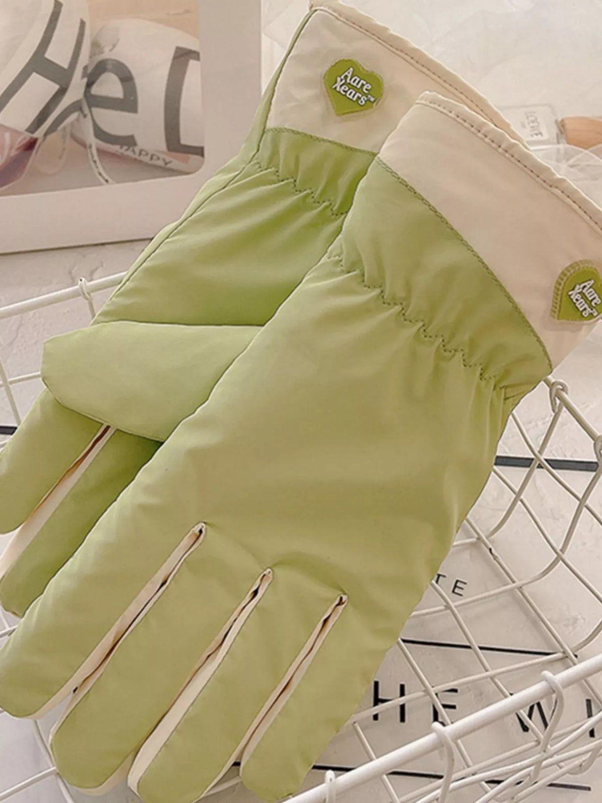 Close-up of gathered glove wrists, cream cuffs and small flower accents.