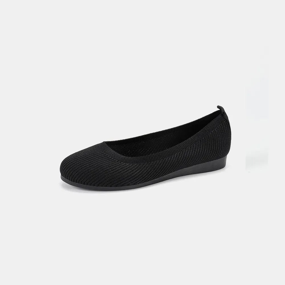 Black knit ballet flat shown from the side on a plain background.