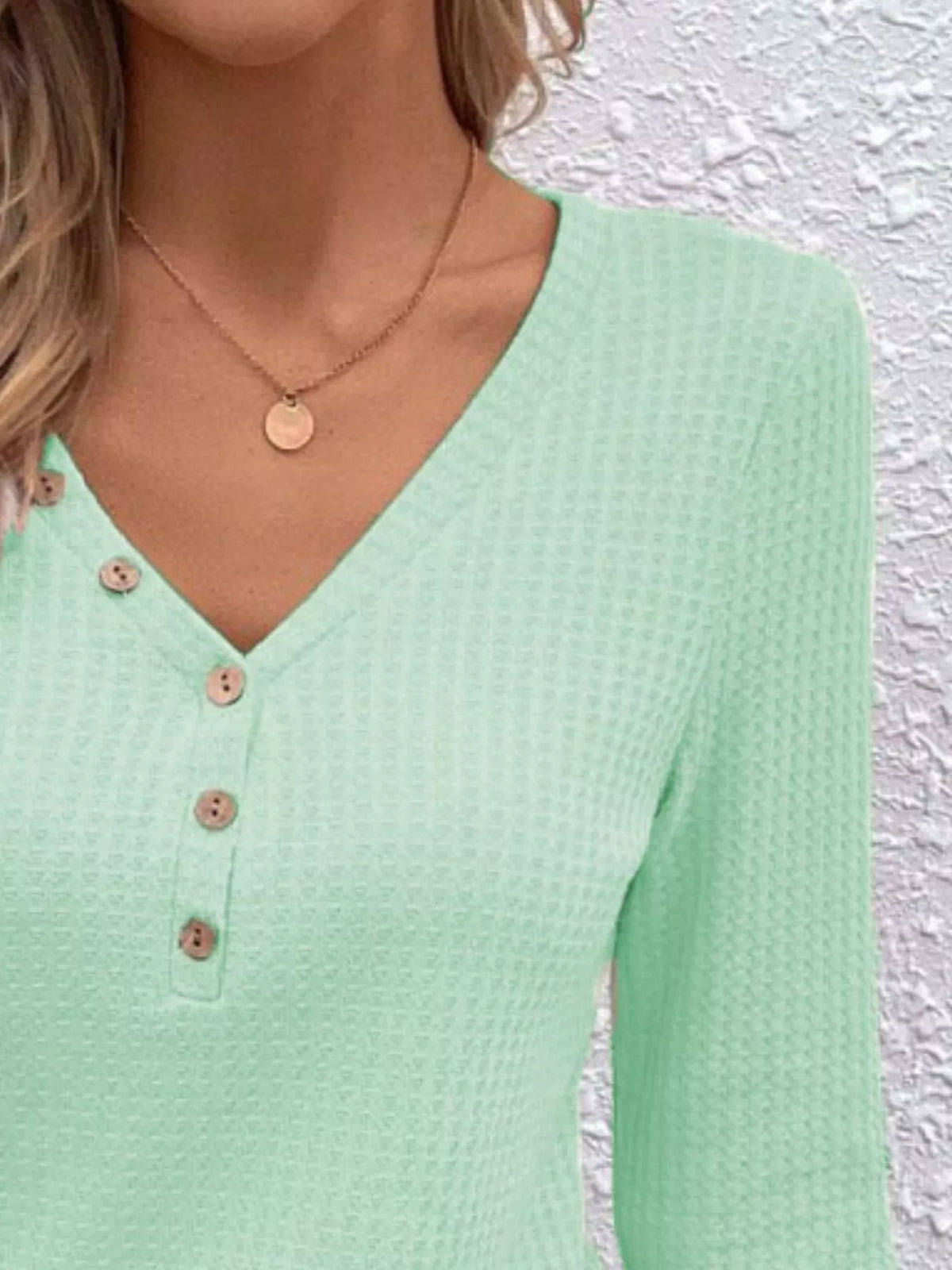 Close view of the Gum Leaf top showing its waffle texture, V-neck and buttons.