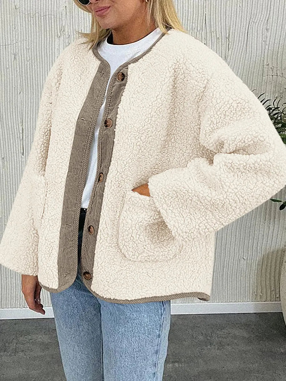Cream textured jacket worn with a white T-shirt and blue jeans, showing its patch pockets.