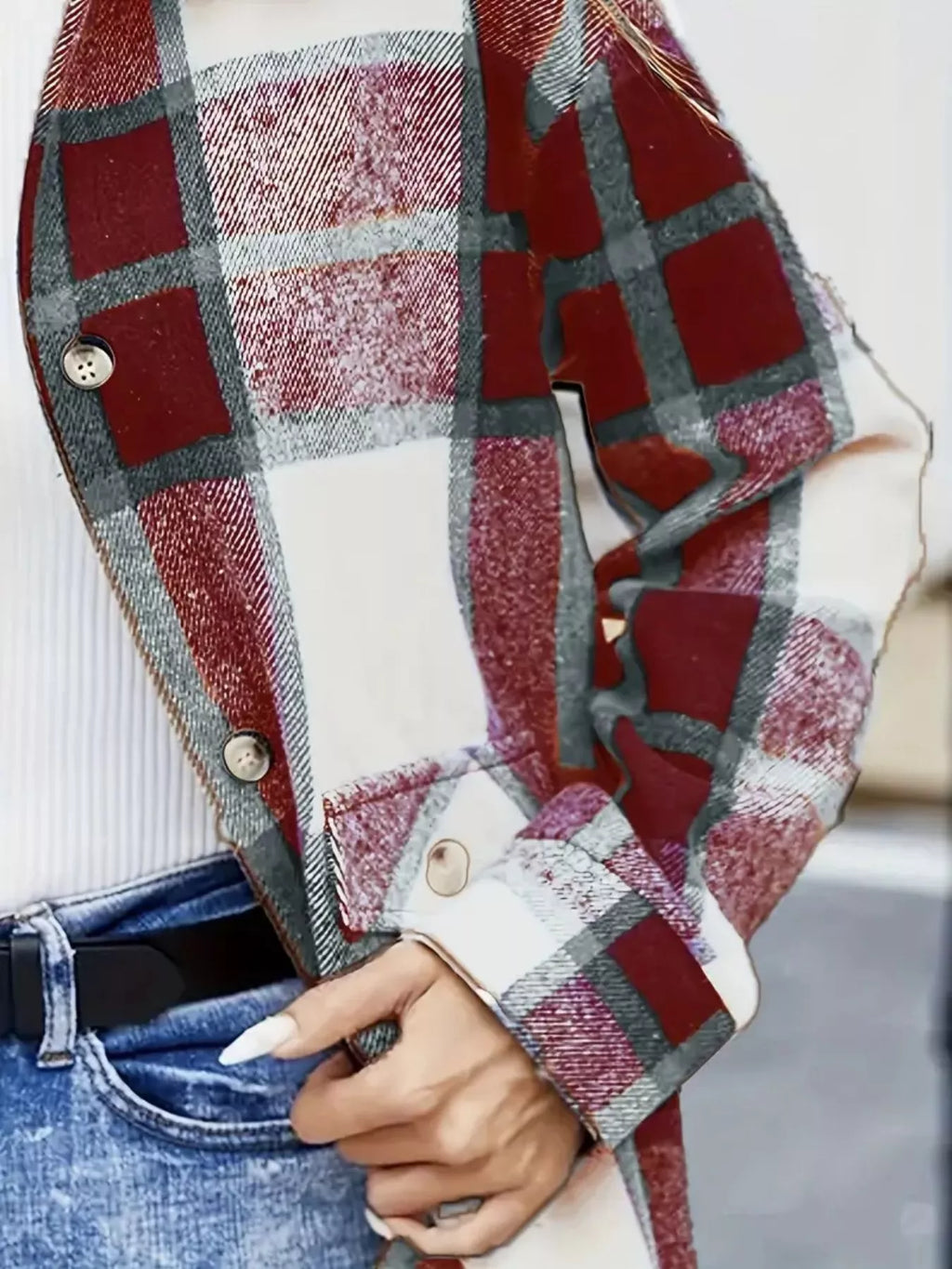 Close-up of the red plaid shacket's front buttons, pocket flap and sleeve cuff.