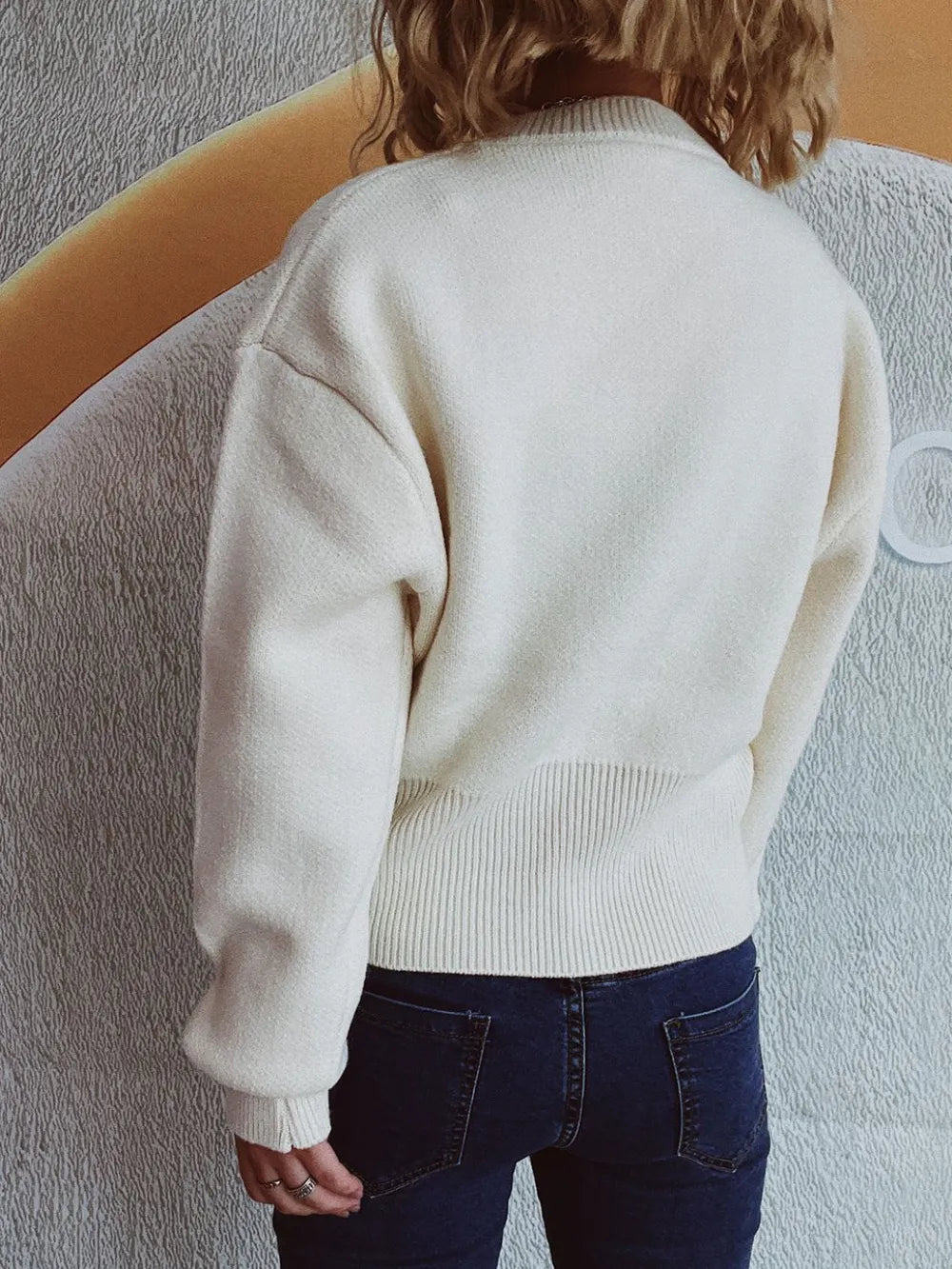 Back view of the White half-zip knit sweater.