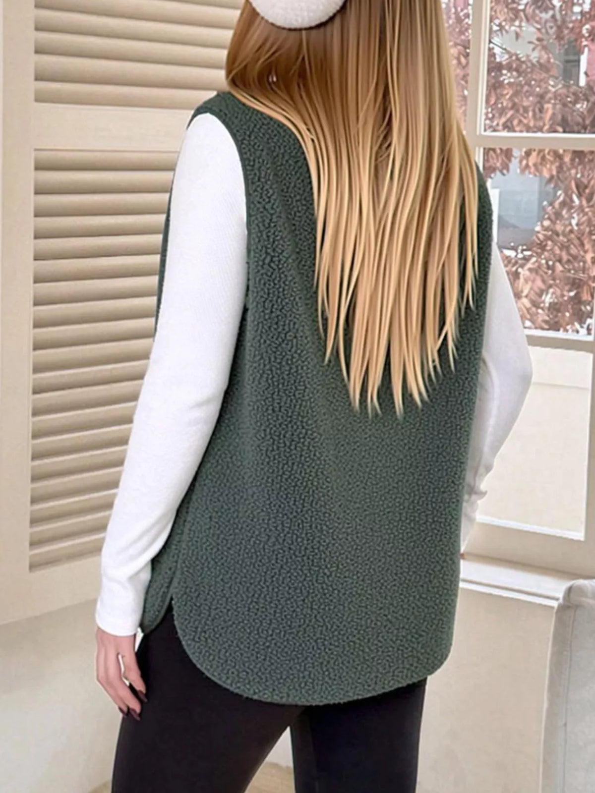 Back view of the Dark Green sherpa vest showing its rounded hem.