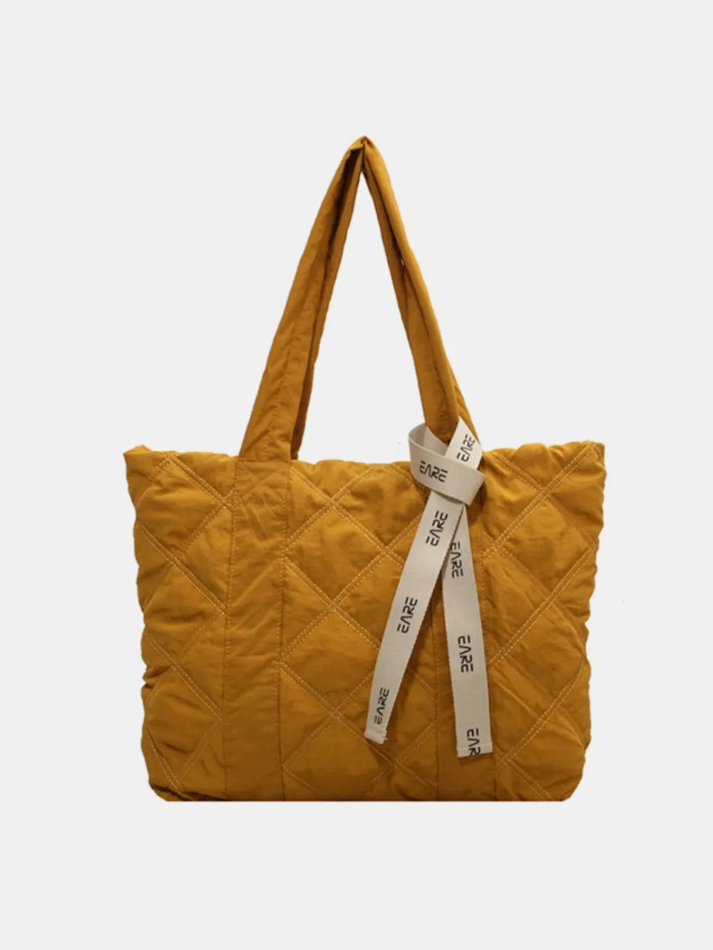 Mustard yellow quilted tote with long handles and a cream ribbon.