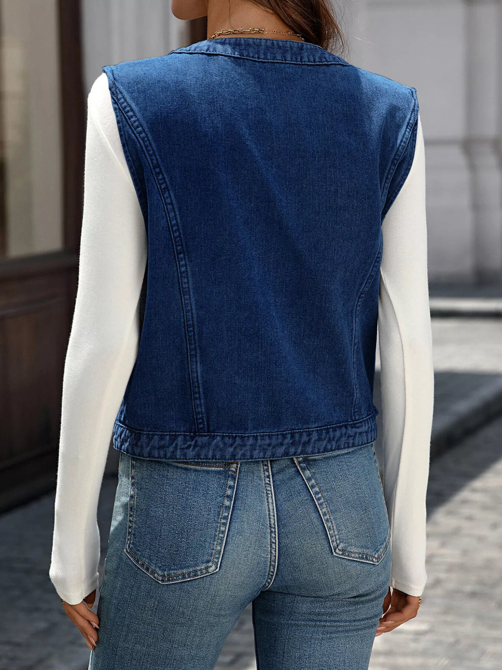 Back view of the Navy sleeveless vest showing its straight hem.