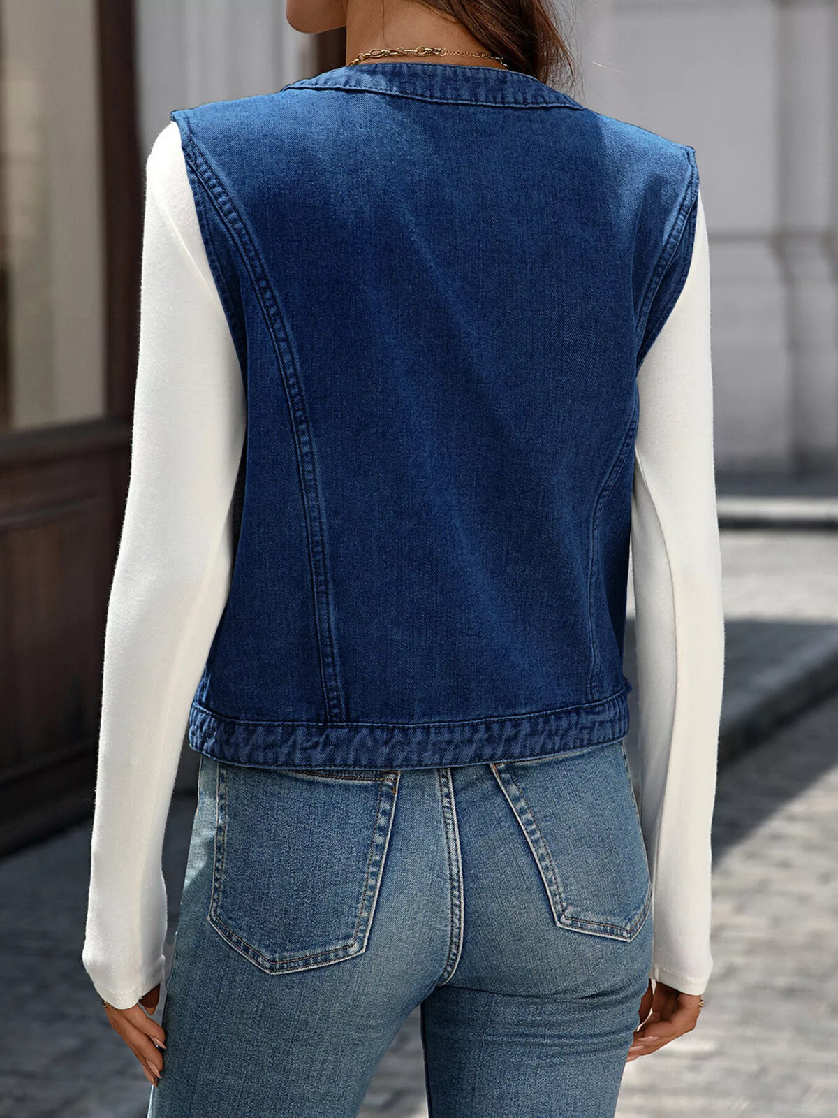 Back view of the Navy sleeveless vest showing its straight hem.