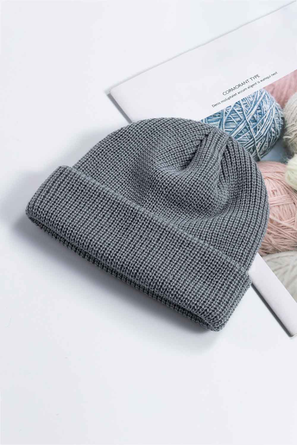 Gray knit beanie shown with its cuff folded up.