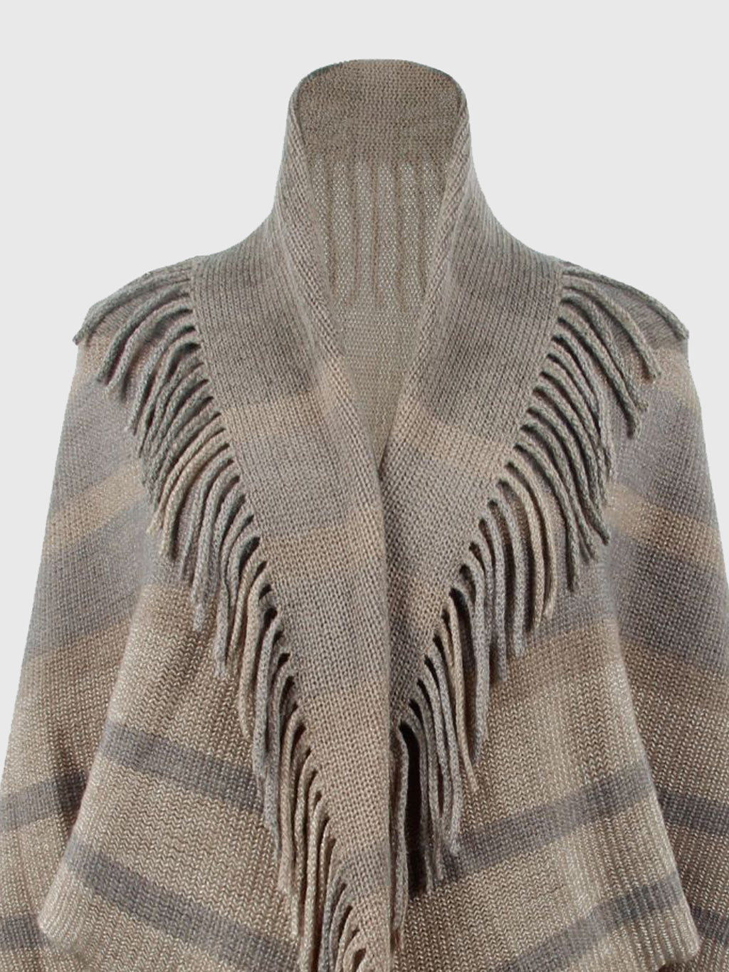 Close-up of the taupe poncho's open neckline, stripes and fringe.