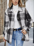 Black, gray and white plaid shacket worn open over a white turtleneck.