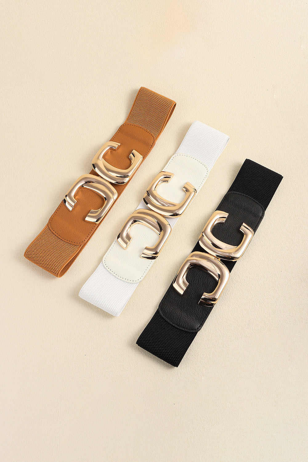 Caramel, white and black waist belts shown together as color options.