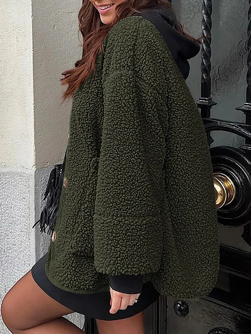 Rear three-quarter view of the olive green textured jacket with a curved hem.