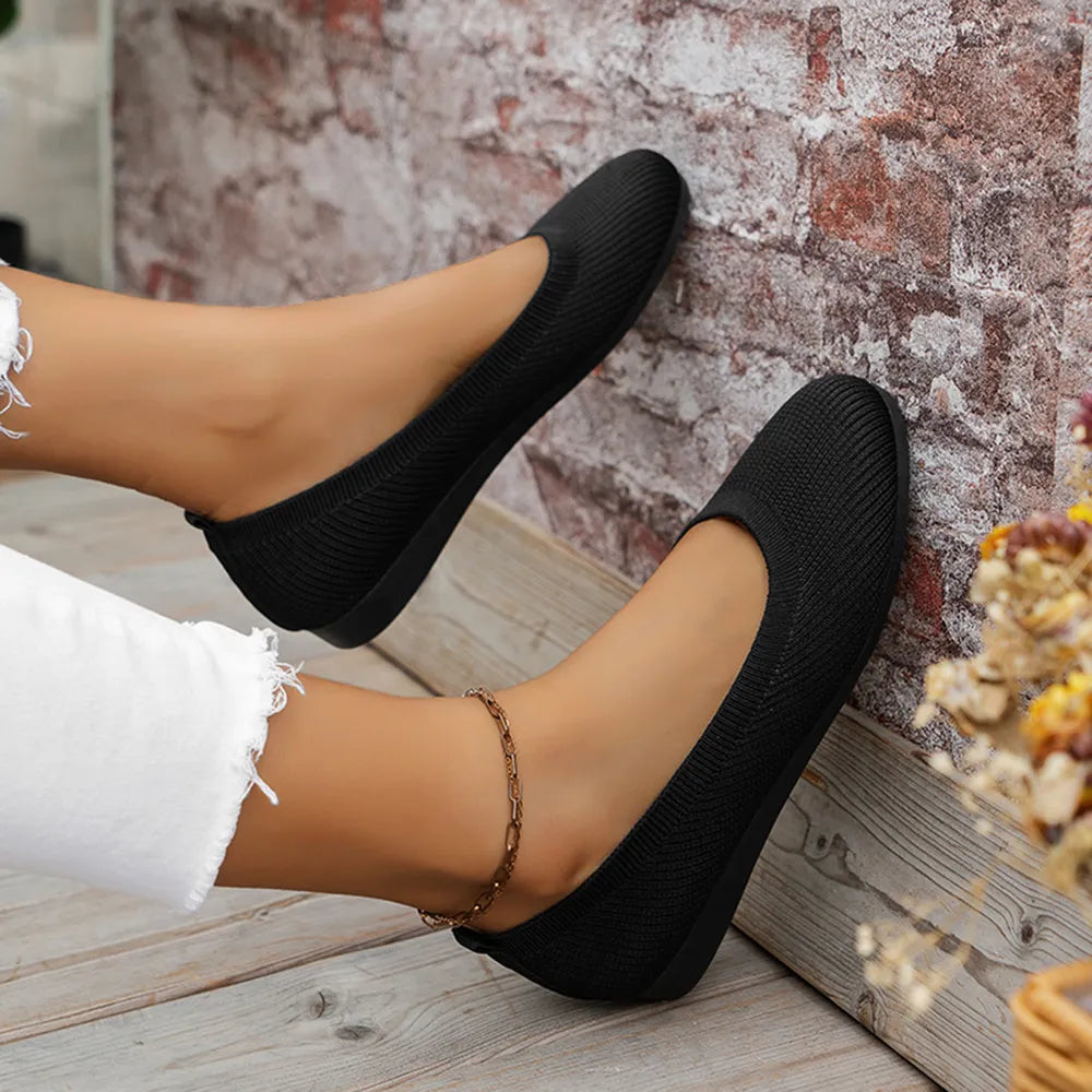 Top view of black knit ballet flats.