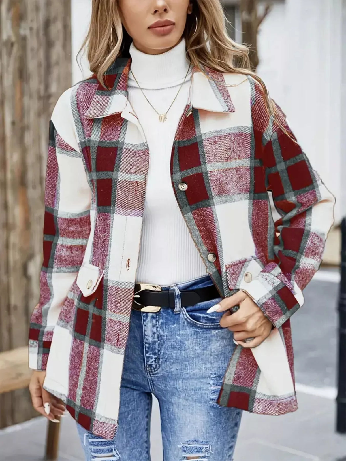 Red and cream plaid shacket worn open over a white turtleneck and jeans.