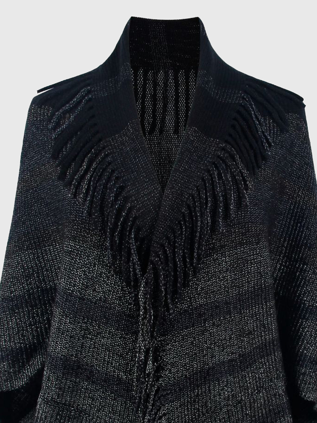 Close-up of the black poncho's open neckline, stripes and fringe.