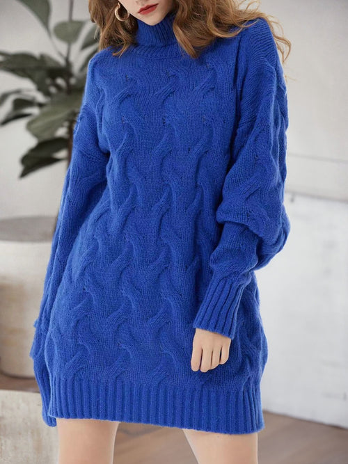 Front view of a blue cable-knit mini sweater dress with long sleeves and a ribbed hem.