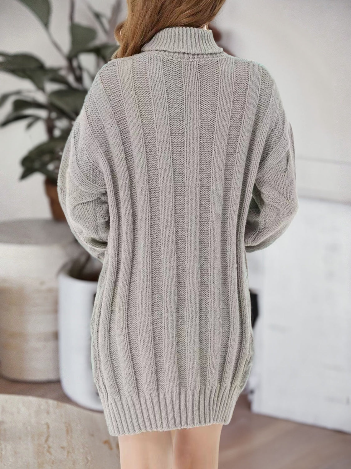 Back view of the light gray sweater dress showing vertical knit ribs.