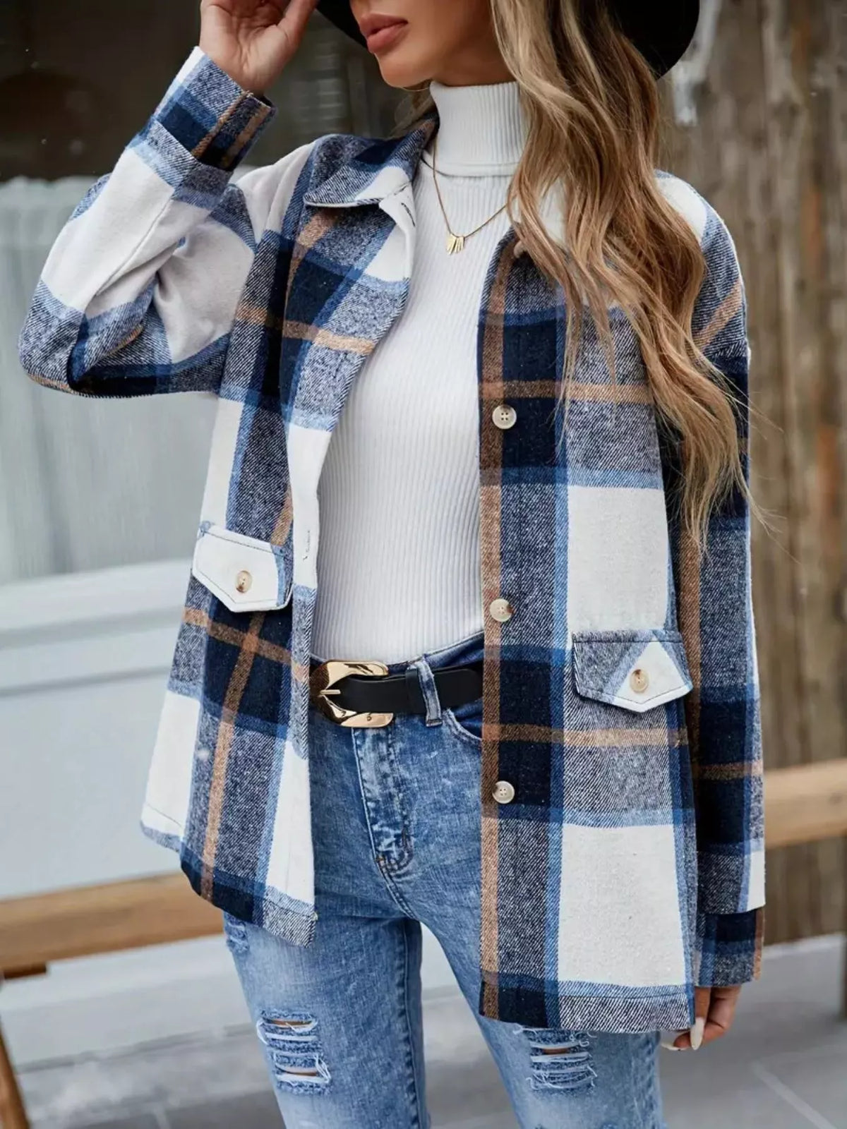 Blue and white plaid shacket worn open over a white turtleneck and jeans.