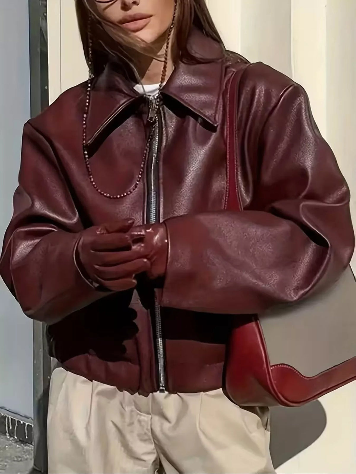 Burgundy faux leather jacket showing the front zipper and wide collar.