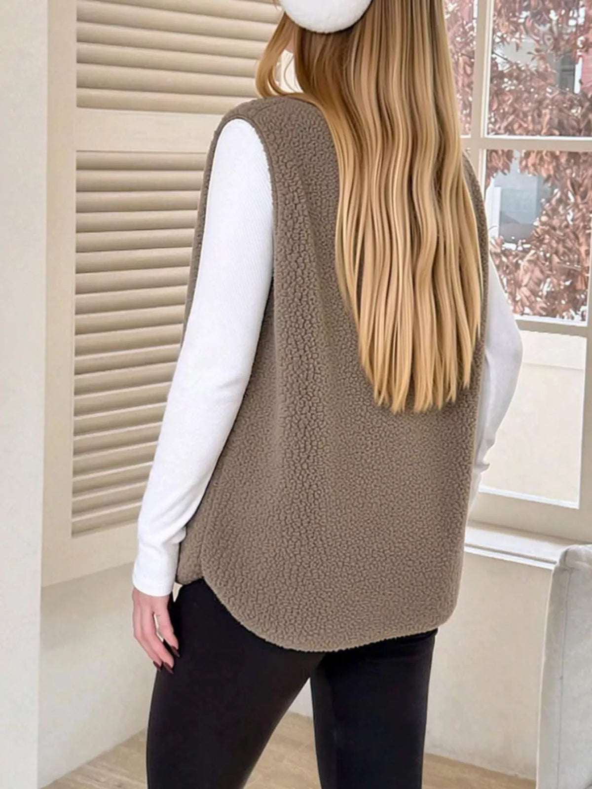 Back view of the Khaki sherpa vest showing its rounded hem.